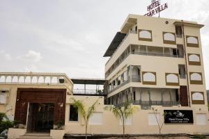 a building with a sign on top of it at Kesar Villa By DSR Group in Bedla