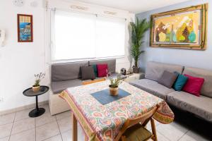 una sala de estar con una mesa y un sofá en Deluxe Appartement, Charmant, au cœur du centre-ville, NICE CENTRE, en Niza