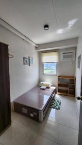 a bedroom with a large bed in a room at Ann Cozy Living in Cebu City