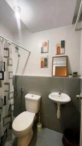 a bathroom with a toilet and a sink at Ann Cozy Living in Cebu City