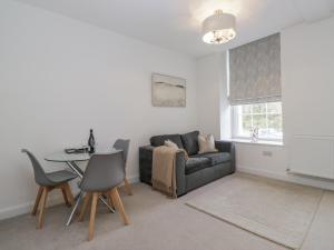 a living room with a couch and a table at Derwent in Ulverston