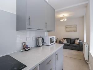 a kitchen with a counter top with a microwave at Derwent in Ulverston