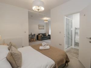 a bedroom with a bed and a living room at Derwent in Ulverston