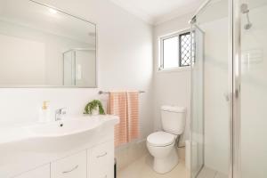 a bathroom with a toilet and a sink and a shower at Smart Suites Self Check-in Apartments - S Freney in Brisbane +37 photos