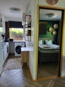 a small room with a bed and a mirror at Golden apartment- parking, wifi and sauna in Raisio