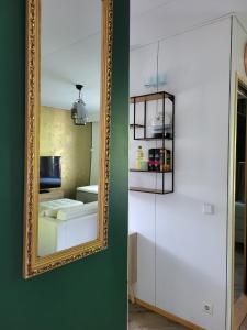 a mirror on a wall next to a room at Golden apartment- parking, wifi and sauna in Raisio +18 photos