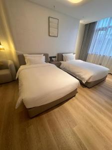 Ένα ή περισσότερα κρεβάτια σε δωμάτιο στο Dejia Hotel +2 φωτογραφίες