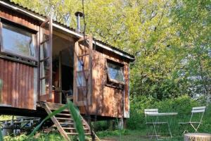 ein alter Eisenbahnwaggon mit einem Tisch und Stühlen in der Unterkunft Totnes - Cabin - Sleeps 4 - Garden - Parking in Totnes