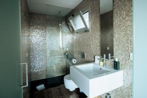 a bathroom with a white sink and a toilet at Moonkey - Casa El Cabo in Balcon del Mar