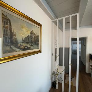 a painting hanging on a wall in a room at QUEEN HOME Emanuelle in Venice