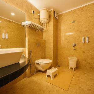a bathroom with a toilet and a sink at The Kempty Osasis - A Boutique Resort With Scenic Mountain View in Mussoorie in Mussoorie