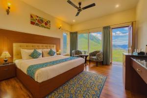 a bedroom with a bed and a large window at The Kempty Osasis - A Boutique Resort With Scenic Mountain View in Mussoorie in Mussoorie