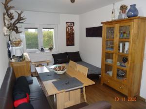 a living room with a couch and a table at Kleine Einliegerwohnung- komfort Home! in Lahnau +10 photos