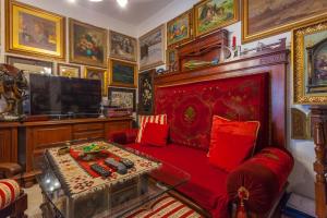 a living room with a red couch and a tv at Studio Makarska 11063d in Makarska