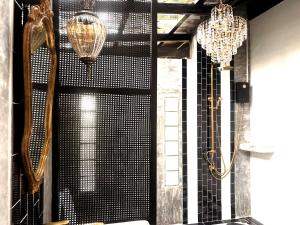 a room with two chandeliers on the wall and a mirror at Barefoot Project formerly Baan Klong Kleng in Ko Phayam +133 photos