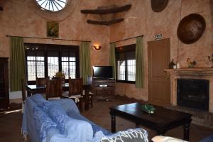 a living room with a couch and a fireplace at Finca Lagarillo with private Pool in Cómpeta