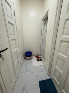 a hallway with two doors and a tile floor at Waridi is a modern, cosy penthouse in Mtwapa town in Mtwapa