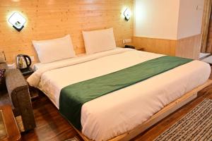 a bedroom with a large bed in a room at Hotel DS Villa in Zirakpur