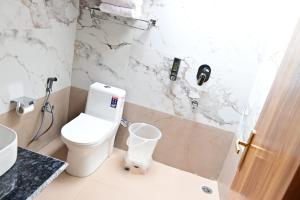 a bathroom with a toilet and a sink at Hotel DS Villa in Zirakpur