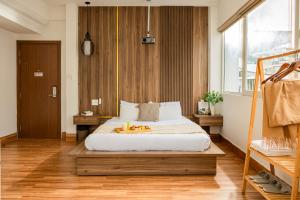 a bedroom with a large bed in a room at The Morris Central Hotel - O'TEL in Da Lat +25 photos