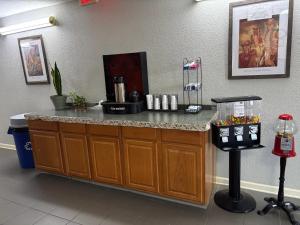 a counter in a waiting room with a coffee machine at Econo Lodge Yazoo City in Yazoo City