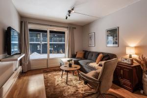 a living room with a couch and a table at Geilo Town Centre - Apartment with a Superb Location and walking Distance to Everything in Geilo