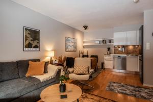 a living room with a couch and a table at Geilo Town Centre - Apartment with a Superb Location and walking Distance to Everything in Geilo