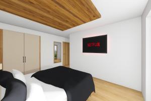 a bedroom with a white bed with a black comforter at PUREALPS Apartment - Opening December 2025 in Schwendberg