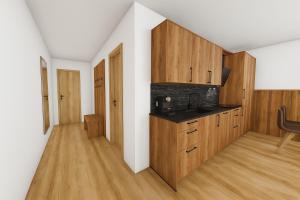 a room with a kitchen with wooden cabinets at PUREALPS Apartment - Opening December 2025 in Schwendberg