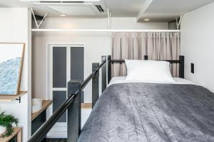 a bedroom with a bed and a balcony at Hotel Edge Nakasu in Fukuoka +73 photos
