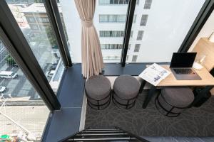 an office with a desk with a laptop on it at Hotel Edge Nakasu in Fukuoka