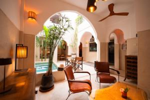 a living room with an archway and a pool at Riad Dar Amazonia in Marrakesh