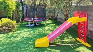 a playground with a slide and a swing at Family-friendly apartments with swimming pool Jelsa, Hvar - 22432 in Jelsa