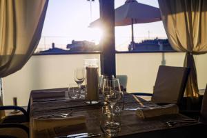 a table with wine glasses on top of it at Rooms with a swimming pool Peroj, Fazana - 24329 in Vodnjan