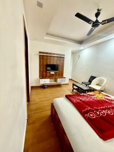 a bedroom with a bed and a tv in a room at Moti Mahal Delux in Bahādurgarh