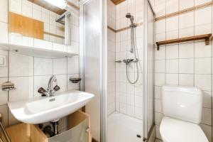 a bathroom with a toilet sink and a shower at Panorama Ferienwohnung Tschengla in Bürserberg +17 photos