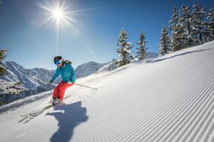 a woman is skiing down a snow covered slope at Panorama Ferienwohnung Tschengla in Bürserberg