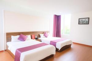 a hotel room with two beds and a window at Phúc Lộc Hotel Ninh Bình in Ninh Binh +20 photos