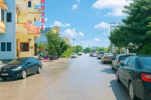 a street with cars parked on the side of the road at Phúc Lộc Hotel Ninh Bình in Ninh Binh