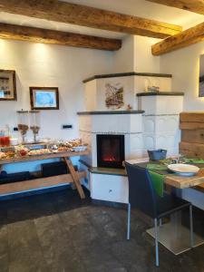 a living room with a fireplace and a table and a tableablish at Al Sole B&B Valcomelico in Santo Stefano di Cadore +48 photos
