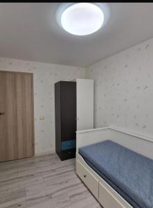a bedroom with a bed and a cabinet in it at Pas Dianą 1 aukštas in Jurbarkas