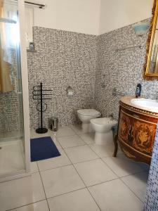 a bathroom with a toilet and a tub and a sink at One M in Borgarello +63 photos
