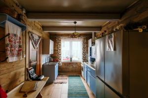a kitchen with a refrigerator and a window at Dom na wsi u Kasi HAJNÓWKA BIAŁOWIEŻA NA WYŁĄCZNOŚĆ in Stare Berezowo