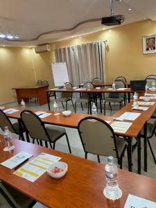 a room with wooden tables and chairs and a classroom at Divine Guest Lodge in Rustenburg