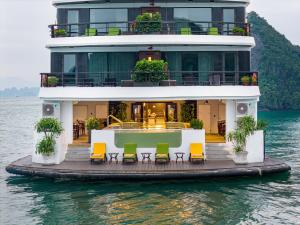 a house on a boat in the water at L'amour Cruise in Ha Long