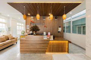 a lobby with a couch and a reception desk at The Morris Central Hotel - O'TEL in Da Lat