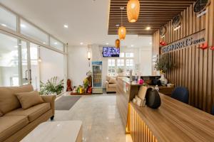 a store lobby with a couch and a table at The Morris Central Hotel - O'TEL in Da Lat
