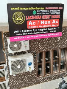 a sign on a wall with a speaker and a microwave at Lakshman Guest House Ayodhya in Jāmb