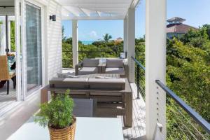 a porch with couches and a view of the ocean at Wyakha Duplex 1 & 2 in Long Bay Hills