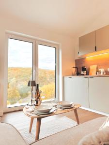 a living room with a table and two windows at Tiny House mit Whirlpool und Sauna in Bermel +25 photos